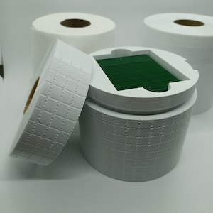 May include: White cardboard tubes with a green insert. The tubes have a textured pattern and are stacked on top of each other.