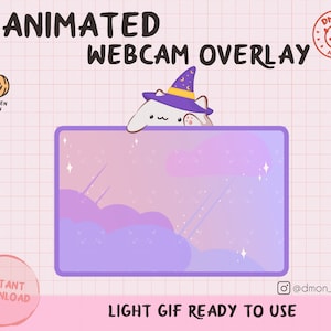 May include: An animated webcam overlay featuring a white cat wearing a purple witch hat with yellow stars. The rectangular frame has a purple border and a gradient background of pink and purple clouds with small white sparkles and diagonal lines.
