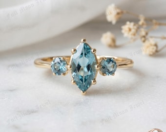 Anillo de tres piedras con topacio azul marquesa en plata de ley 925, estilo vintage, ideal para bodas.