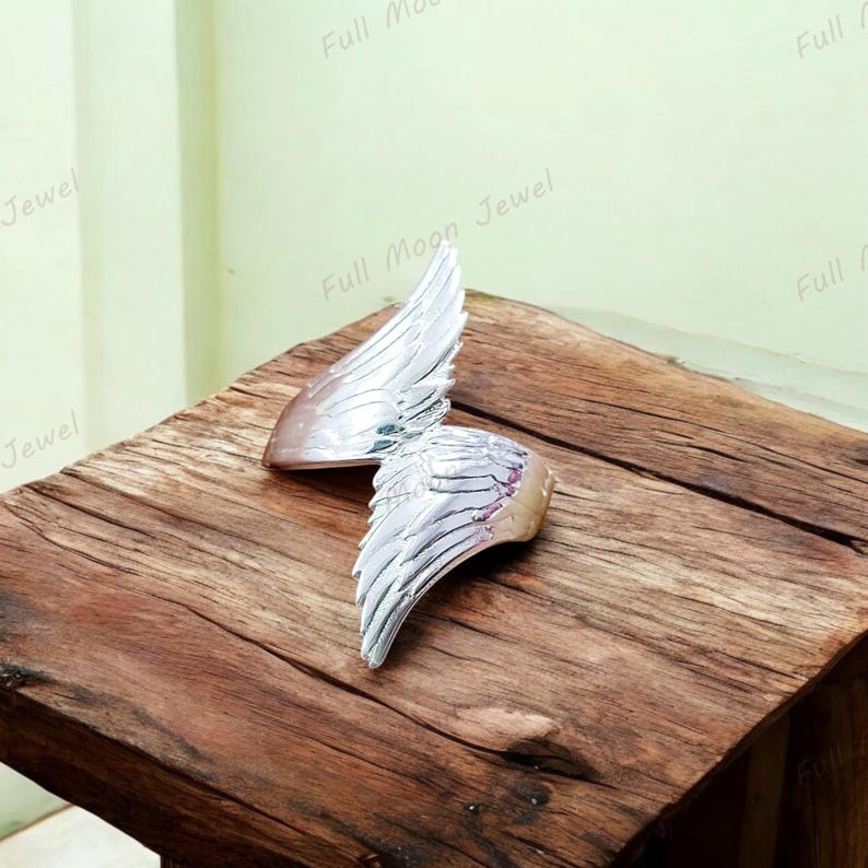 Elegant feather ring symbolizing freedom, faith, and spirituality.