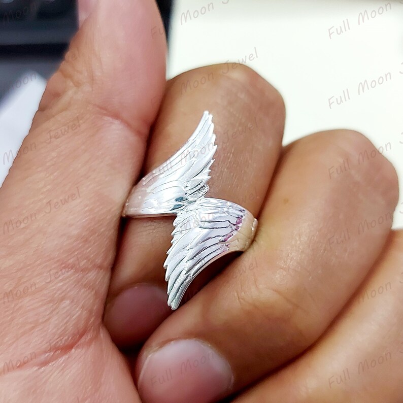 Angel wings open band ring symbolizing guidance and protection.