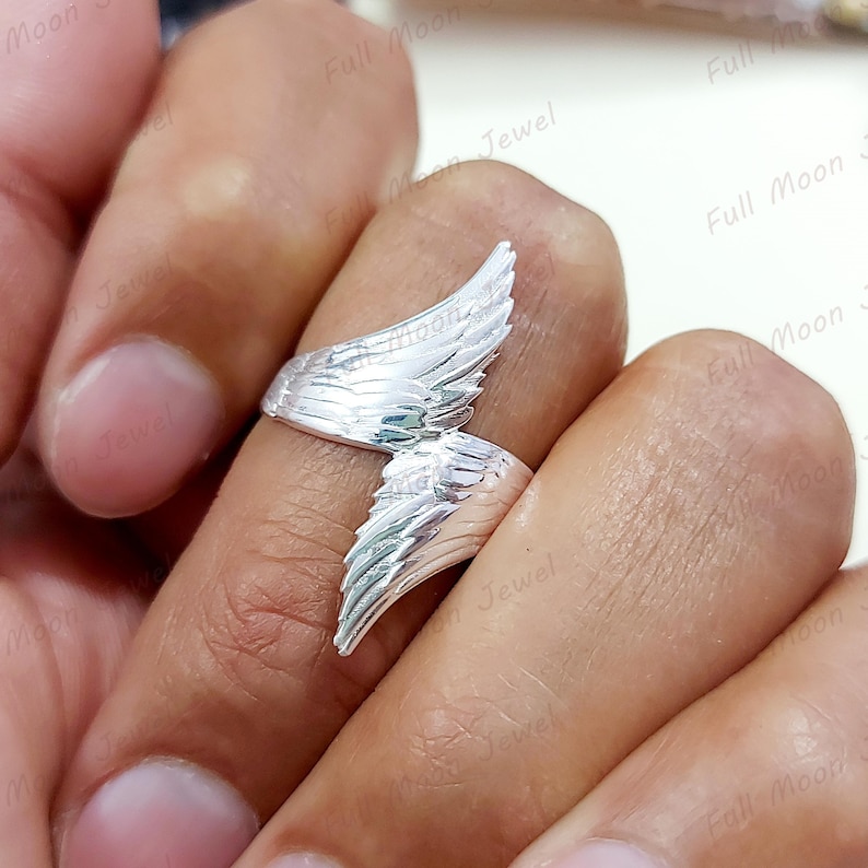 Handmade angel wing ring with oxidized silver detail.