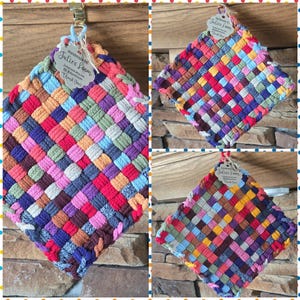 May include: A square potholder featuring a multi-colored woven pattern in shades of red, blue, yellow, green, purple, and orange. A white tag attached to the top corner displays the text "Handmade by Julie's Loom" with social media icons.