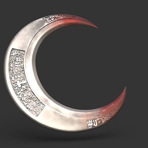 May include: A silver crescent-shaped blade with etched patterns and a reddish hue on the edges. The curved weapon has a sharp point and is likely a decorative or collectible item.
