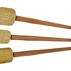 May include: Three wooden paint brushes with a flat, rectangular brush head and a long, thin wooden handle.