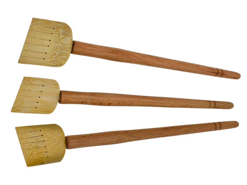 May include: Three wooden paint brushes with a flat, rectangular brush head and a long, thin wooden handle.