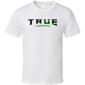 May include: White t-shirt with the words "TRUE LACROSSE" printed on the front. The word "TRUE" is in a bold, black font with a green and black camouflage pattern. The word "LACROSSE" is in a green font.