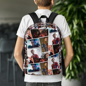 May include: A black backpack with a colorful print of various characters from the Spider-Man universe. The print features a variety of characters, including Spider-Man, Miles Morales, and other heroes and villains.