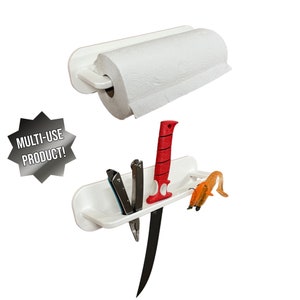 May include: White multi-use product with a paper towel holder and a shelf with knives and fishing lures. The paper towel roll is white. The shelf holds a black knife, a red knife, and two other tools. The text "MULTI-USE PRODUCT!" is in a starburst.