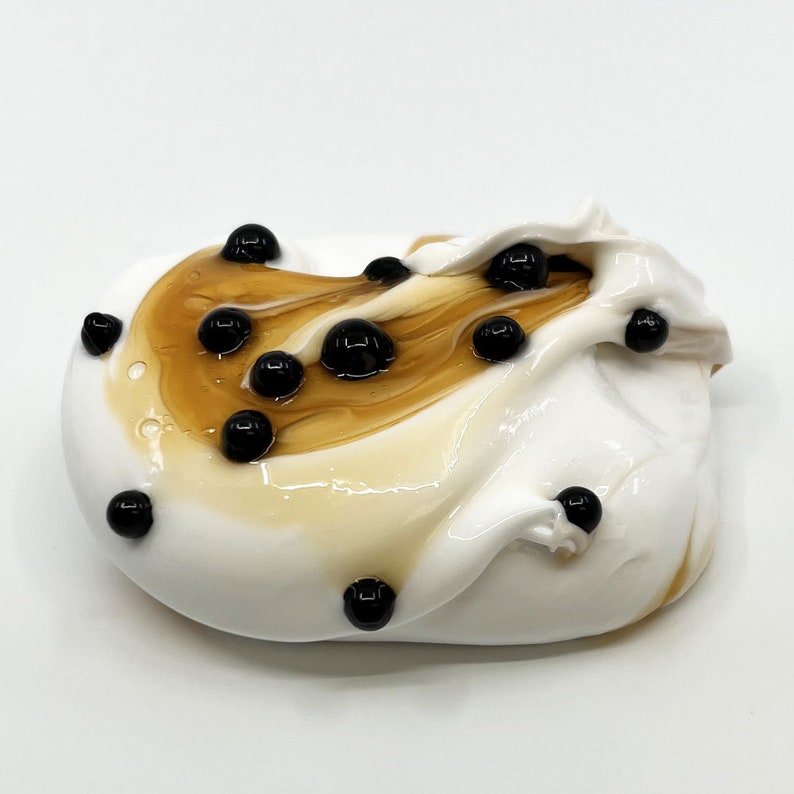 May include: White slime with brown swirls and black boba pearls.