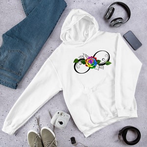 May include: White hoodie with a large graphic of a rainbow rose and infinity symbol. The design features a colorful rose in the center of the infinity symbol, with black swirls and green leaves. The hoodie has a front pocket and a hood.