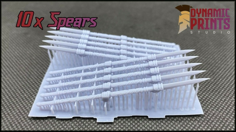May include: A set of 10 white plastic spears, arranged in rows on a white plastic tray. The spears are all the same size and have a pointed tip. The tray is labelled "10 x Spears" and "Dynamic Prints Studio".