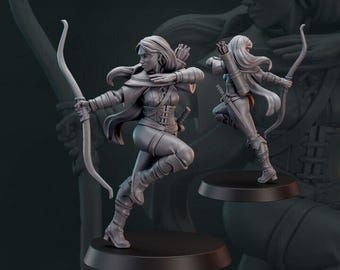 May include: A gray figurine of an archer in a dynamic pose, drawing a bow. The figure is clad in detailed medieval-style clothing, with a quiver on the back. The base is a dark, circular shape. The word "GALAAD" is at the top.