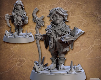 May include: A gray painted miniature figurine of a fantasy character. The character is a small humanoid with pointed ears, wearing a hooded cloak and holding a book and a staff. The figurine is standing on a round base.