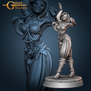 May include: A grey, detailed miniature figurine of a woman wearing a mask and a flowing skirt. She is posed in a dancing position with one arm raised and the other bent at the elbow. The figurine is set on a round base.