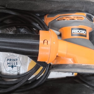May include: An orange and black Ridgid brand electric sander with a black power cord. The sander has a dust collection system and a variable speed control.