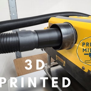 May include: A yellow and black 3D printed dust collection adapter for a wood planer. The adapter has a hose connection and a label that says "PRINT MILLS".