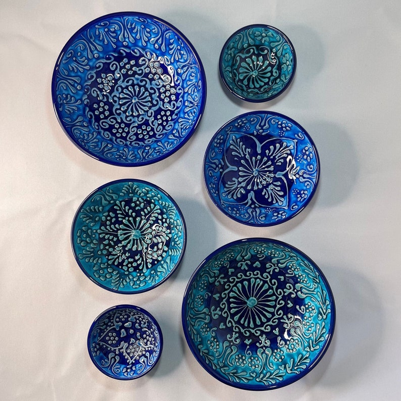 Puede incluir: Conjunto de seis cuencos de cer&aacute;mica azul y blanca con intrincados patrones florales. Los cuencos son de diferentes tama&ntilde;os y son perfectos para servir aperitivos o postres.