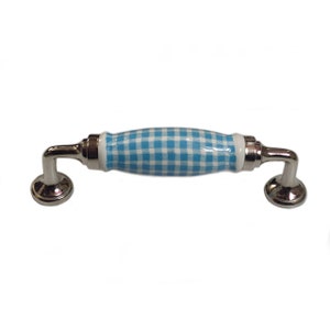 Może przedstawiać: Ceramiczna gałka do szafki w niebiesko-białe kratki z podstawą ze srebrnego metalu.