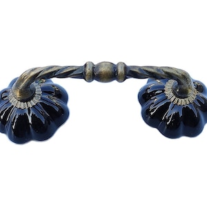 May include: Black ceramic pumpkin shaped drawer pulls with a twisted antique brass finish.