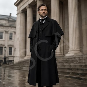 May include: A black floor-length overcoat with a capelet overlay, worn over a matching black vest and white collared shirt with a black necktie. The garment features a structured collar, long sleeves, and a button-down front closure.