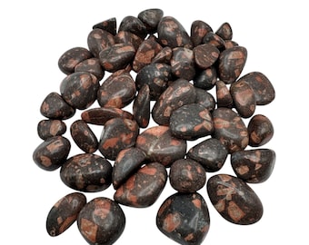 May include: A collection of polished stones with a mix of dark gray and reddish-brown colors. The stones vary in size and shape, with a smooth, rounded appearance. The reddish-brown markings create a speckled pattern across the surface of the stones.