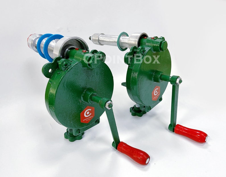 May include: Two green hand crank machines with red handles. The machines have a silver metal roller and a blue plastic ring. The machines are labeled "C" with a red hexagon.