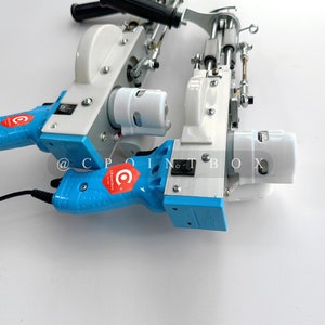 May include: Two blue and white electric sewing machines with a black power cord. The machines have a white plastic casing and a blue handle. The machines have a red and white logo that says "CPointbox".