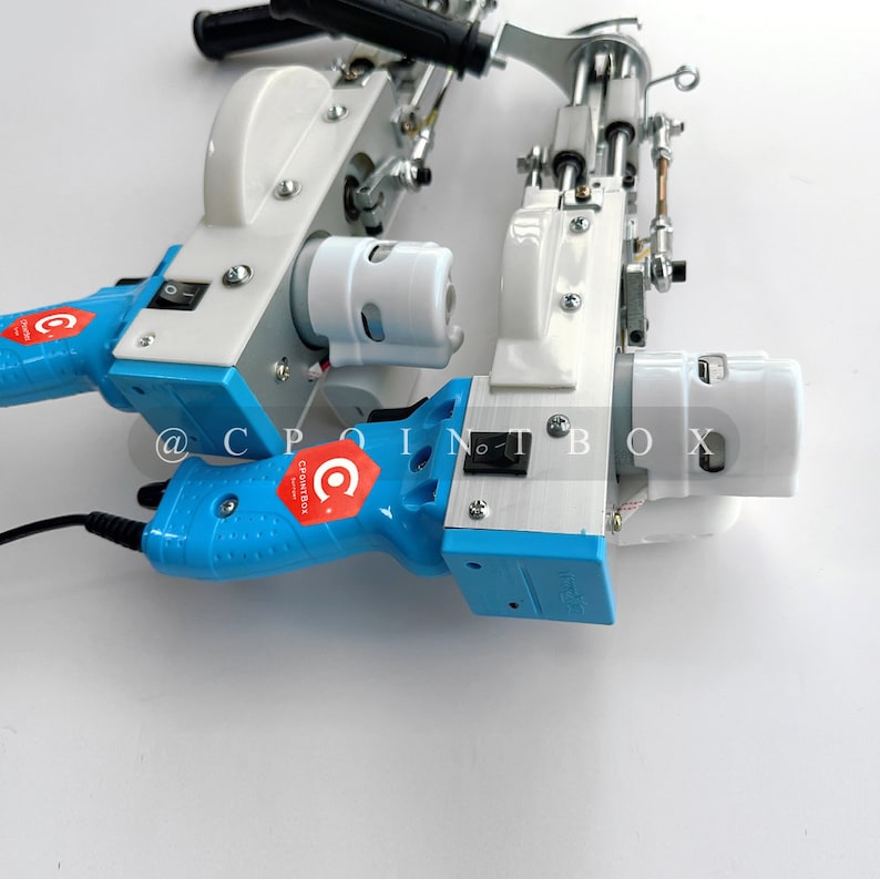 May include: Two blue and white electric sewing machines with a black power cord. The machines have a white plastic casing and a blue handle. The machines have a red and white logo that says "CPointbox".