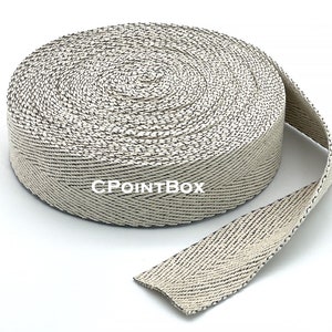 May include: A roll of white and grey woven webbing with a herringbone pattern. The webbing is approximately 1 inch wide and is rolled up in a circle. The text "CPOINTBOX" is printed on the webbing.