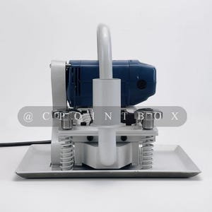 May include: A blue and gray concrete floor grinder with a handle and a base plate. The grinder has a power cord and a switch.
