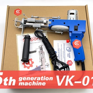 May include: A blue and silver electric sewing machine gun with a black handle and a power cord. The machine is in a cardboard box with the text "5th generation machine VK-01" on the front.