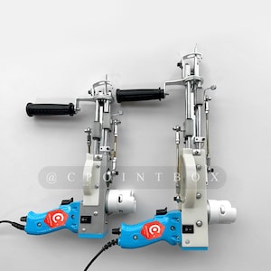 May include: Two blue and white electric fabric cutters with black handles. The cutters have a silver metal mechanism and a black power cord. The text "@CPOINTBOX" is visible on the white background.