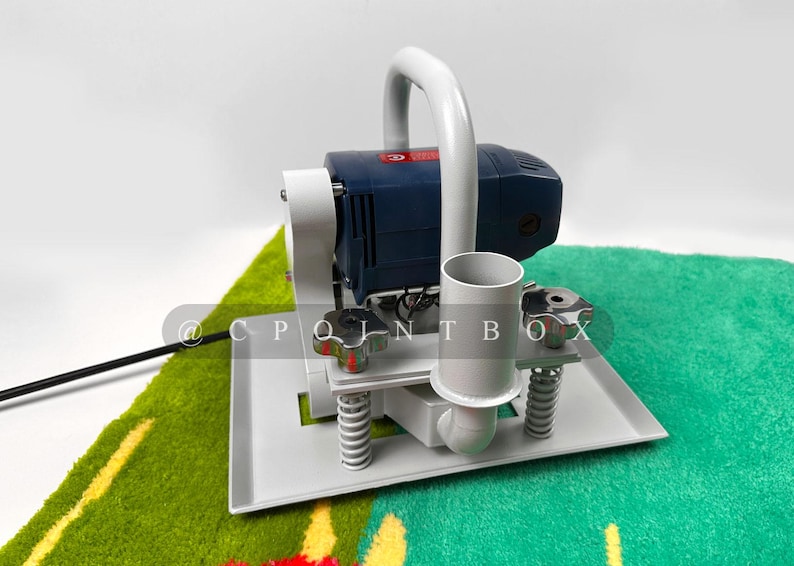 May include: A white and blue electric sander with a handle and a white base. The sander is sitting on a green and yellow rug.