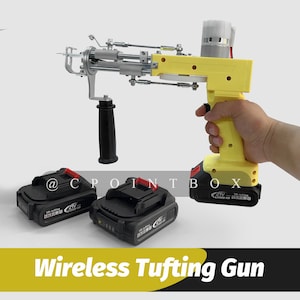 May include: A yellow and black cordless tufting gun with two black battery packs. The gun has a black handle and a silver needle. The text "21V Lithium-ion" is visible on the battery pack.