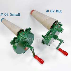 May include: Two green metal cone rollers with a crank handle. The cone rollers are labeled # 01 Small and # 02 Big. The cone rollers are used to roll paper cones.