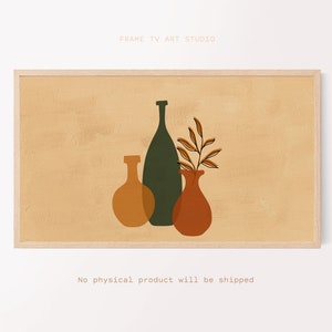 Pode incluir: Impressão de arte abstrata com três vasos estilizados em tons de laranja e verde sobre um fundo bege, emoldurada em madeira clara. O texto "FRAME TV ART STUDIO" está no topo. O texto "No physical product will be shipped" está na parte inferior.