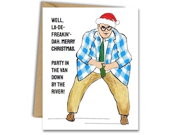 Puede incluir: Una tarjeta de Navidad con un hombre de dibujos animados que lleva un gorro de Papá Noel y una chaqueta a cuadros azul y blanca. El texto de la tarjeta dice "Well, la-de-freakin'-dah. Merry Christmas. Party in the van down by the river!"