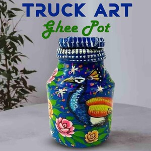 May include: A hand-painted blue glass jar with a peacock design, floral accents, and the text "TRUCK ART Ghee Pot". The jar features a detailed peacock illustration with vibrant colours and a decorative lid.