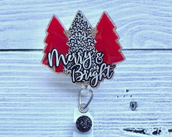 May include: A red and gold glitter Christmas tree badge holder with the text "Merry & Bright".