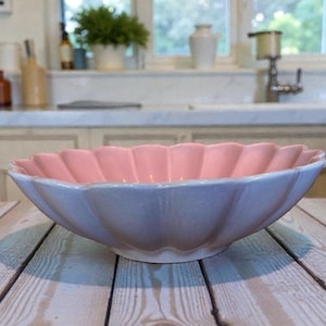 May include: A set of three ceramic mugs with a speckled, matte finish. The mugs are in shades of cream, light gray, and dark gray. Each mug has a simple, minimalist design and a rounded handle.