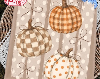 May include: A square canvas print featuring three pumpkins with stitched outlines on a beige background with white polka dots and vertical stripes. The pumpkins display orange plaid, brown plaid, and white with orange polka dot patterns.