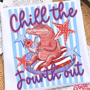 May include: White t-shirt with a patriotic design. The shirt features a red alligator wearing star-shaped sunglasses, relaxing on a float with red, white, and blue stripes. Text reads "Chill the Fourth out" in red and blue.