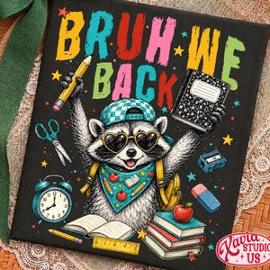 May include: A black rectangular sign featuring a raccoon wearing a checkered cap, heart-shaped sunglasses, and a bandana. The text reads BRUH WE BACK. Surrounding the raccoon are school supplies including a pencil, notebook, scissors, alarm clock, eraser, and books.