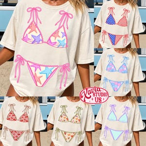 Pode incluir: T-shirts creme com v&aacute;rios designs de biqu&iacute;nis. Os designs incluem padr&otilde;es de estrelas, motivos da bandeira americana, patchwork, estampas florais e padr&otilde;es listrados. Cada design de biqu&iacute;ni &eacute; impresso na frente da camiseta.