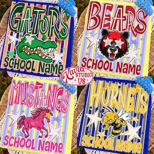May include: Four rectangular graphic prints featuring school mascots and text. One shows a green alligator with the text GATORS SCHOOL NAME, one a bear with BEARS SCHOOL NAME, one a pink horse with MUSTANGS SCHOOL NAME, and one a bee with HORNETS SCHOOL NAME.