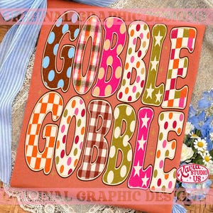 May include: An orange t-shirt featuring the text GOBBLE GOBBLE in large, bold letters. Each letter displays a unique pattern, including blue polka dots, red and green plaid, solid pink, orange and white polka dots, white stars, and orange checkered squares.