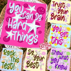May include: Collection of colorful square prints with motivational phrases like "You Can Do Hard Things" and "You Got This." Each print features a star design and smiley faces, with a variety of background colors including pink, blue, and yellow.