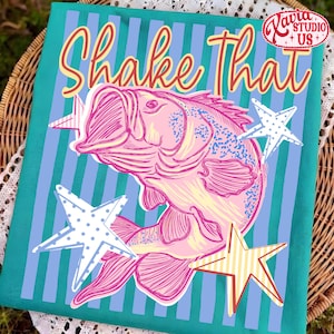 May include: A teal fabric with a pink fish illustration and the words "Shake That" in a retro font. The design includes white, blue, and yellow stars. The image has a vintage, nautical theme.