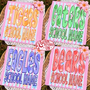 May include: Four pink signs with school team names: Tigers, Gators, Eagles, and Bears. Each sign has a team name in bold, colorful letters with a star accent, and the words "SCHOOL NAME" below. The signs are decorated with flowers.